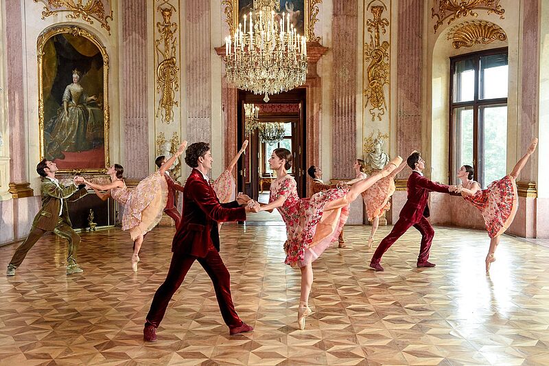Ballettänzer und Ballettänzerinnen in historischem Festsaal